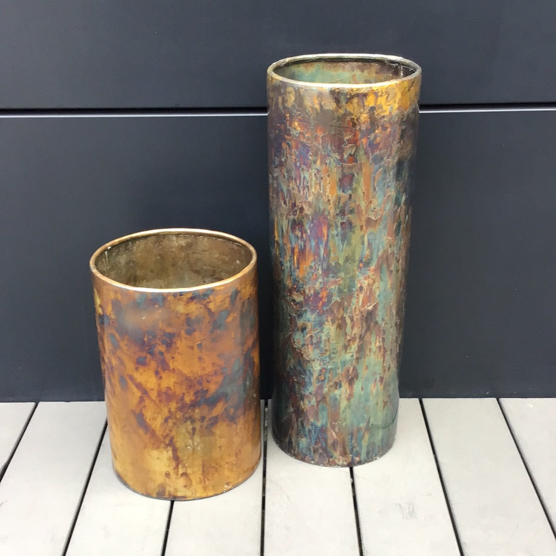 Sleek and modern column vase in murky copper finish. Use to display large branches, or long stem flowers.  Front view
